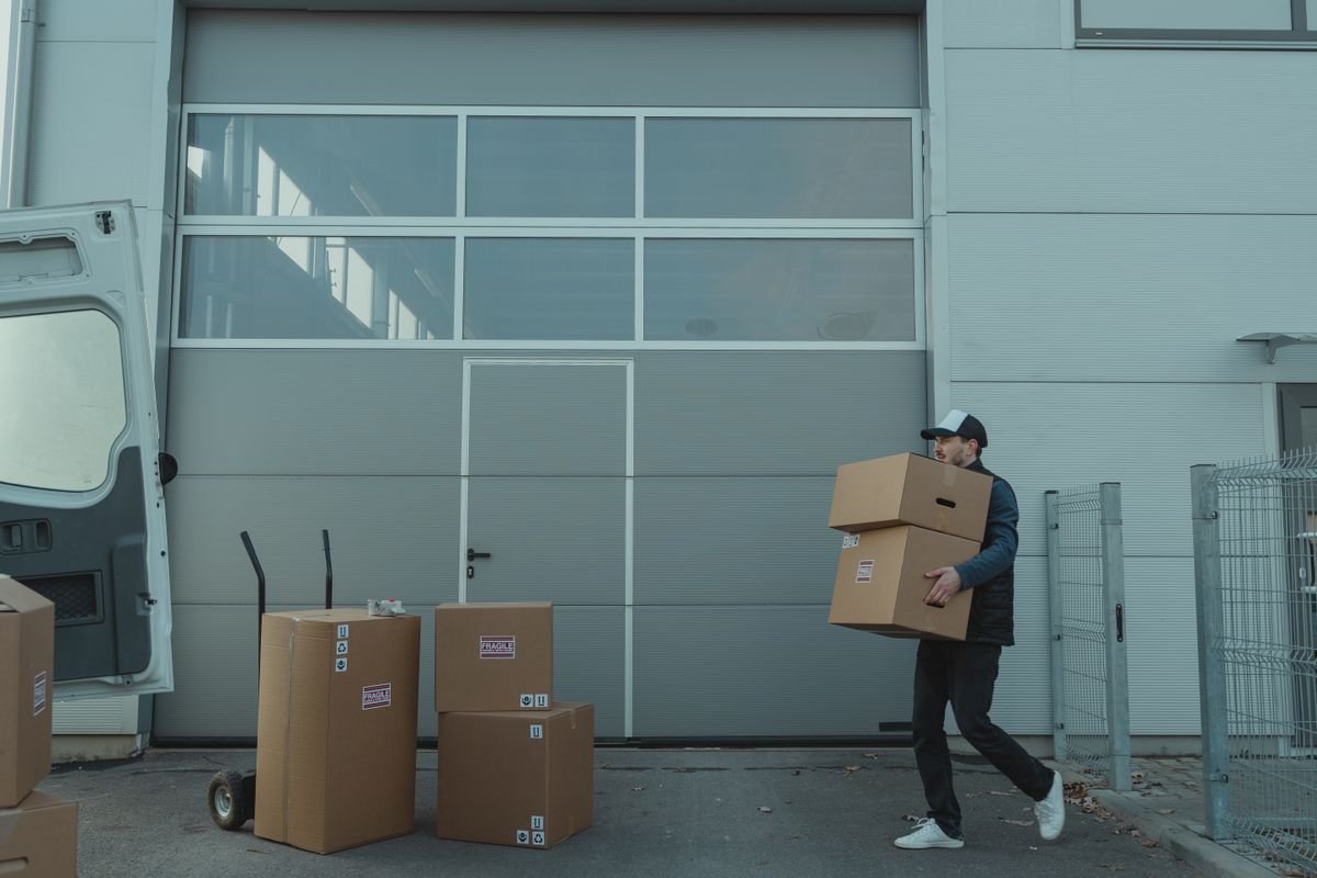 Courier unloading parcels from a delivery van